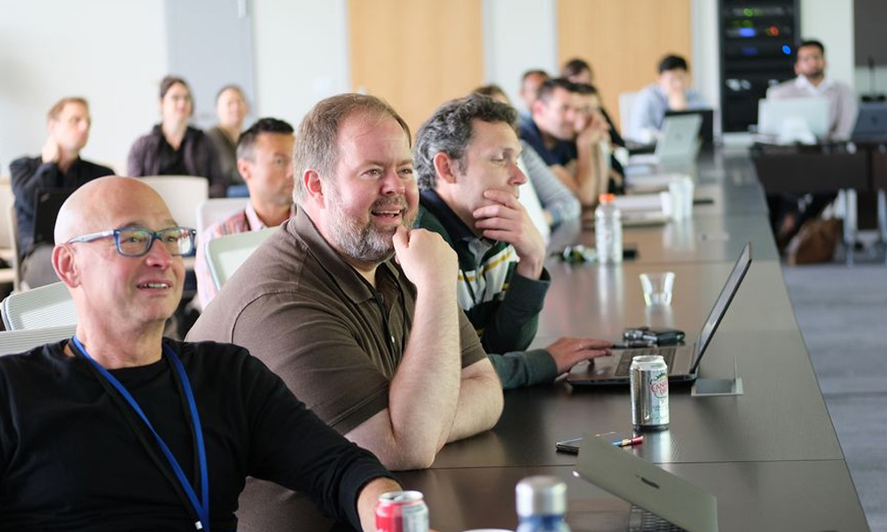 Attendees, including Tim Bussey, listening to a talk during the touchscreen symposium