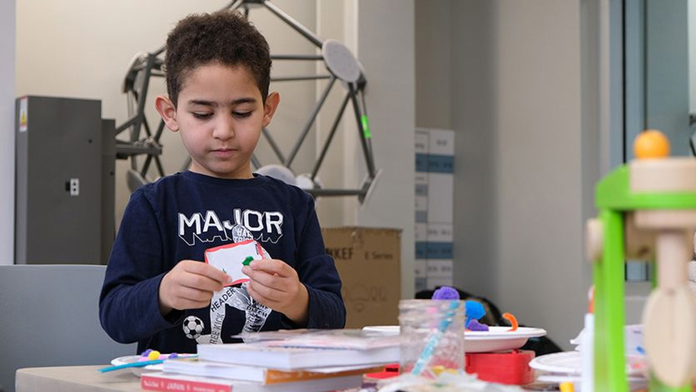 A child plays with sensory-based objects during a day camp held in January 2020 by the Sensory Perception Research lab at Western University.