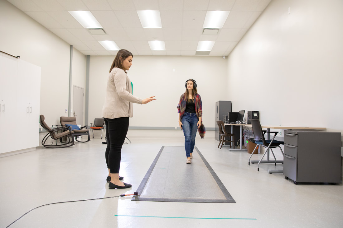 A participant in Grahn's Gait Lab walks to music