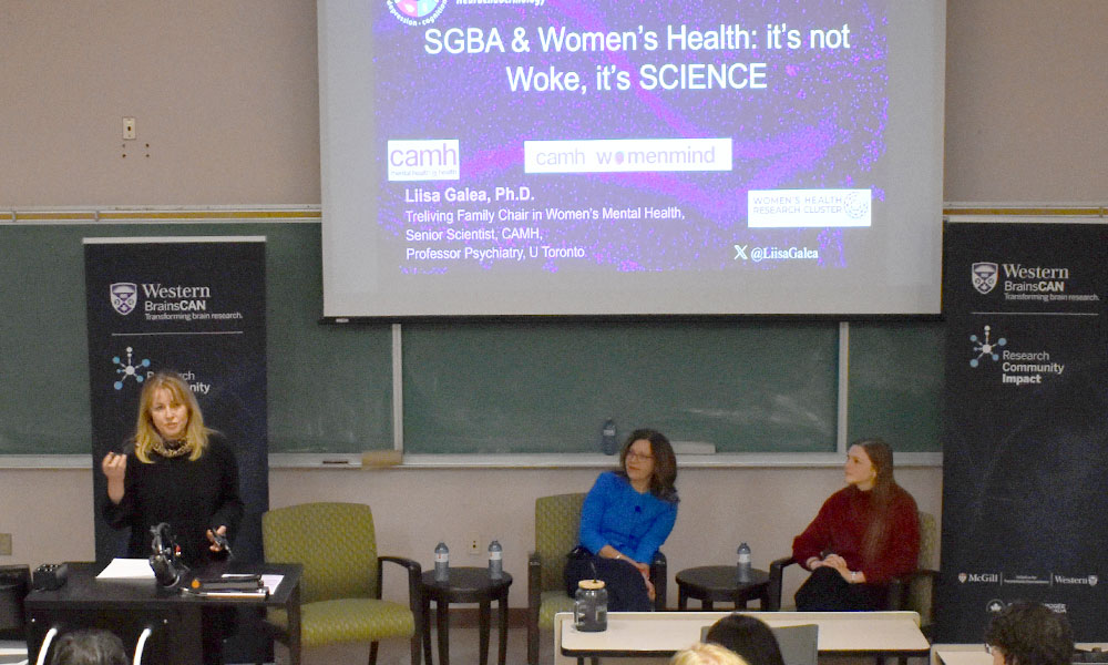 From left, Lisa Saksida, Liisa Galea, and Kendra Loedige speak at a seminar at Western University in February 2026